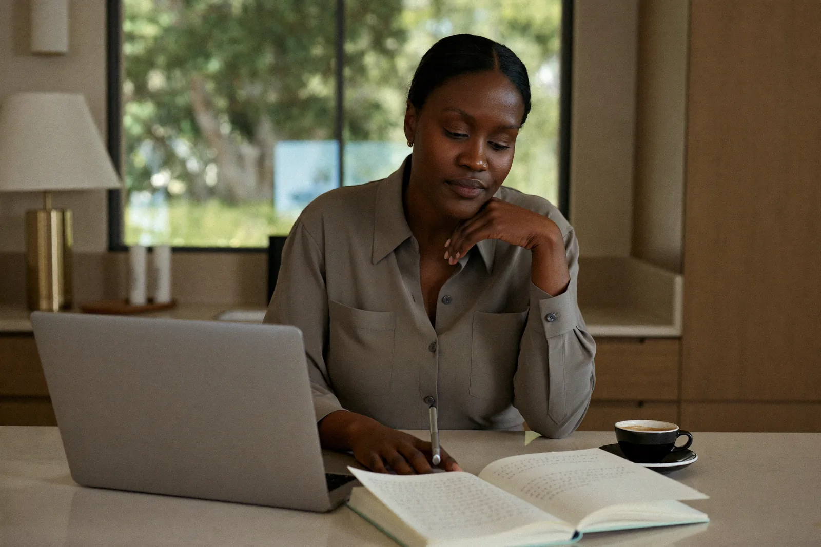 Woman researching how to choose a board-certified plastic surgeon from her home near Dubai.