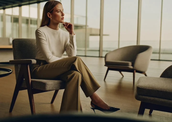 Woman discussing thigh lift surgery options during a consultation in Dubai.